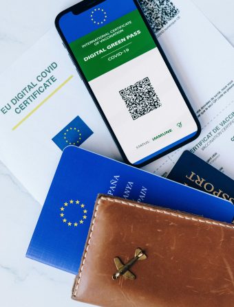 Passport Holder Beside a Cellphone on Top of a Certificate